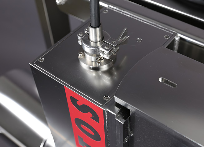 Sample feed with a process sampler connected via a hose and clamp connection